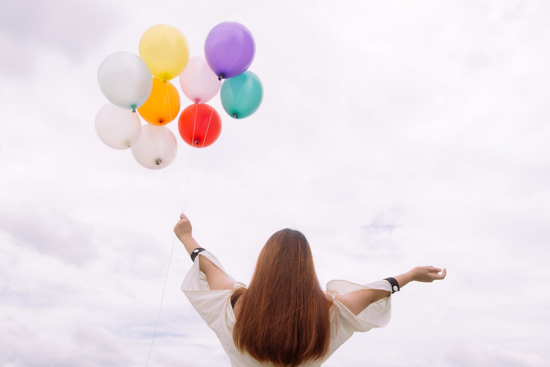 worm s eye view of woman holding balloons